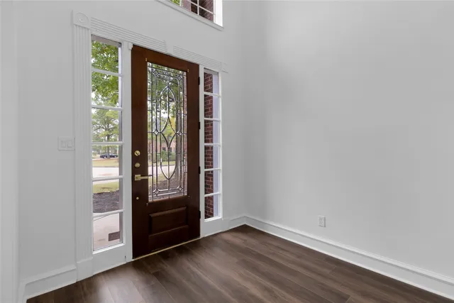 a view of entryway and hall with wooden floor
