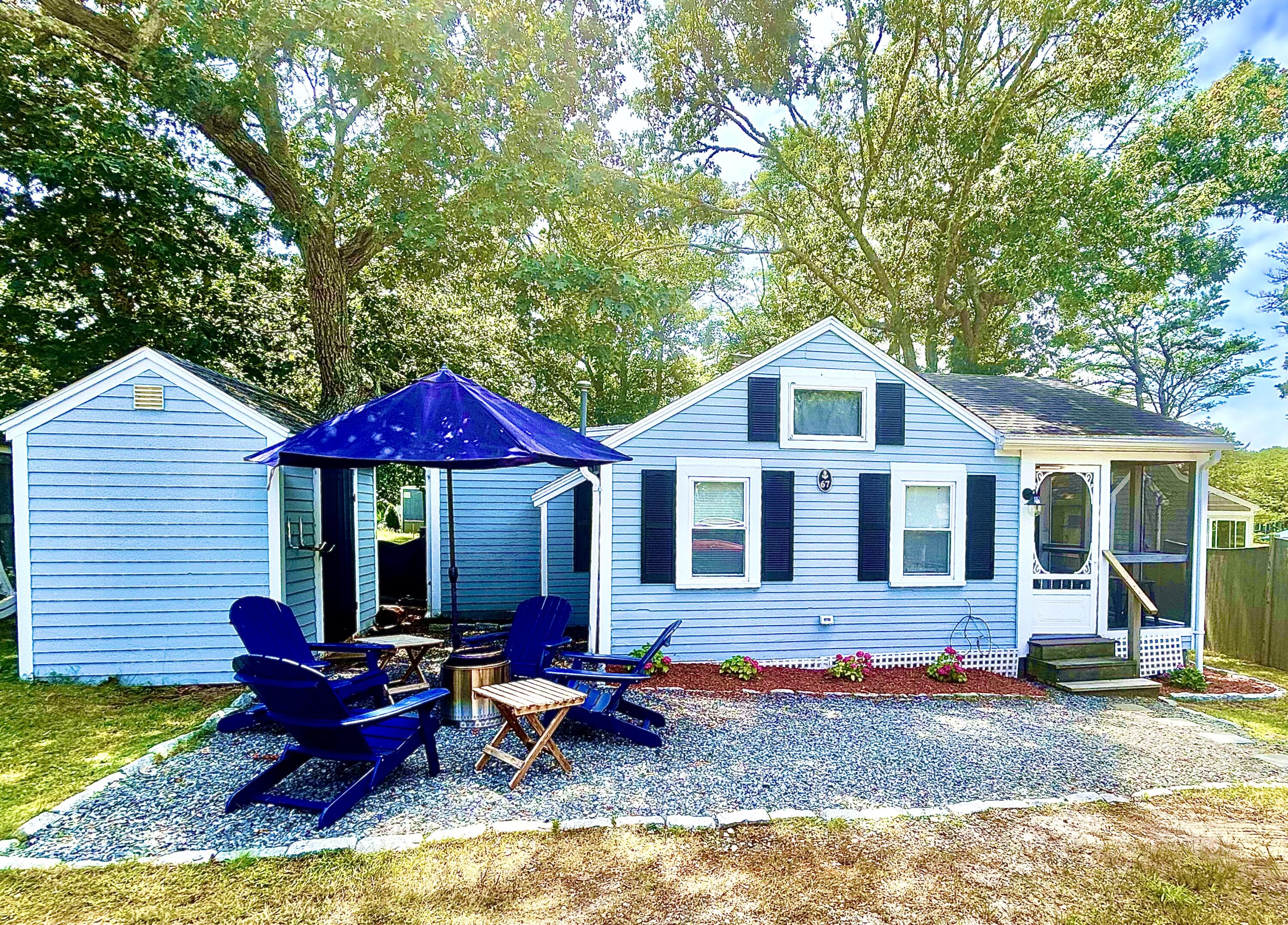 a view of a house with backyard porch and sitting area