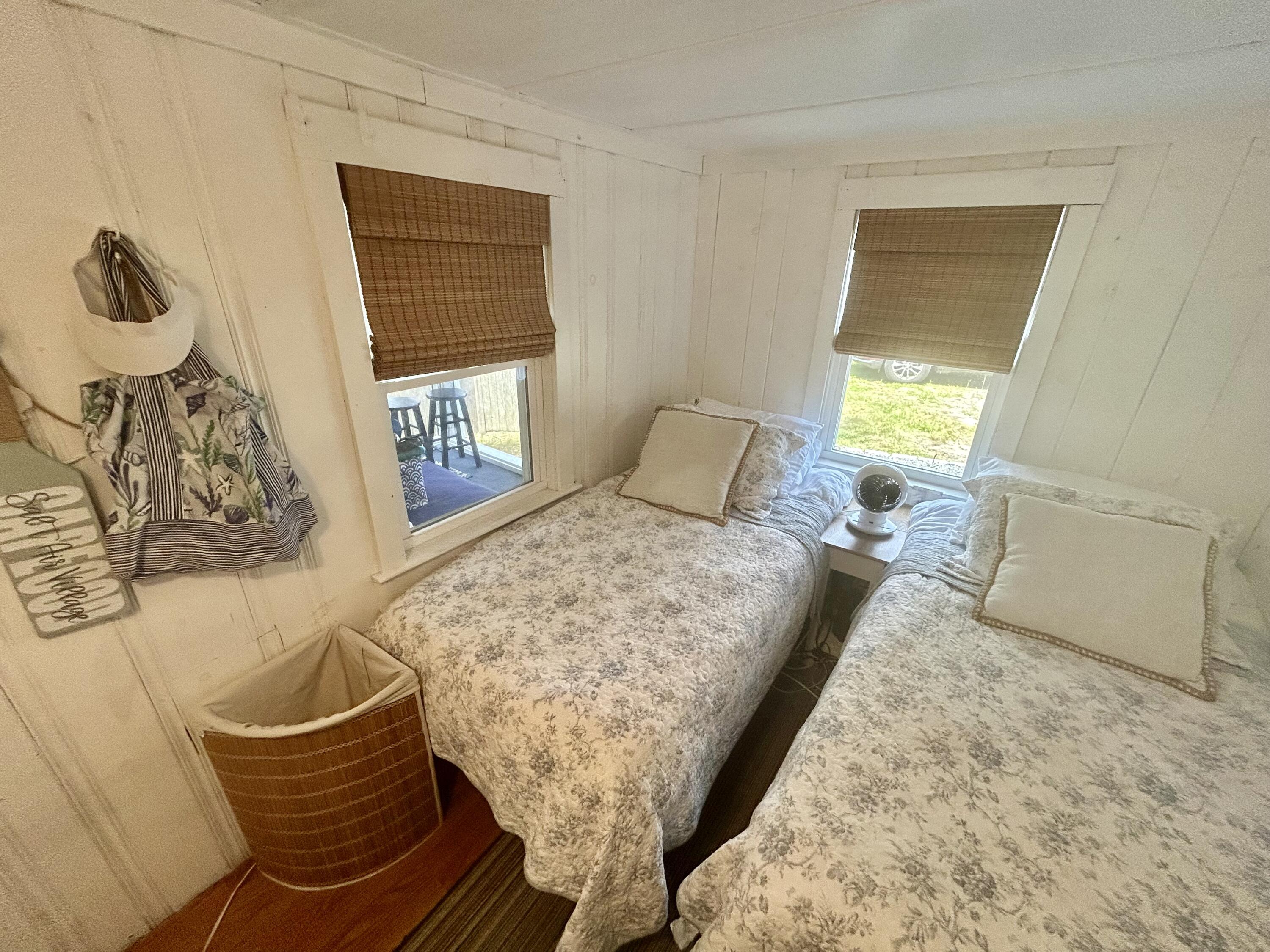 262 Old Wharf Road, Unit U67 Dennis Port, MA 02639 - Photo 15 of 54 a bed sitting in a bedroom next to a window