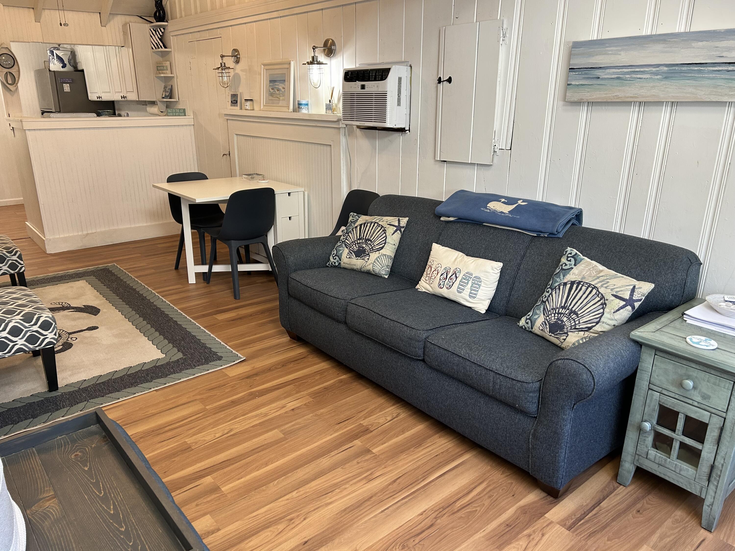 262 Old Wharf Road, Unit U67 Dennis Port, MA 02639 - Photo 19 of 54 a living room with furniture and a wooden floor