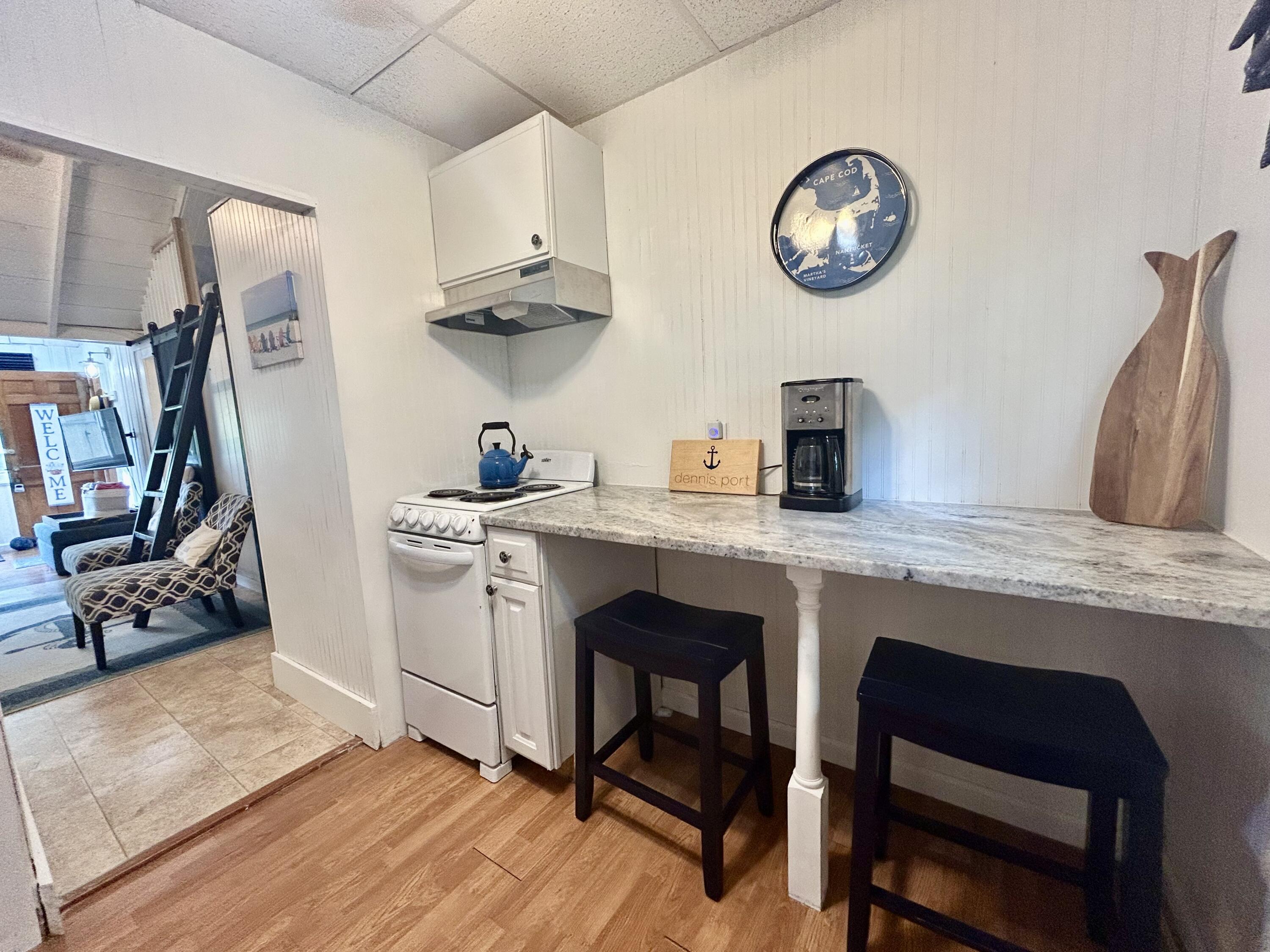 262 Old Wharf Road, Unit U67 Dennis Port, MA 02639 - Photo 21 of 54 a kitchen with stainless steel appliances granite countertop a stove a sink and a refrigerator