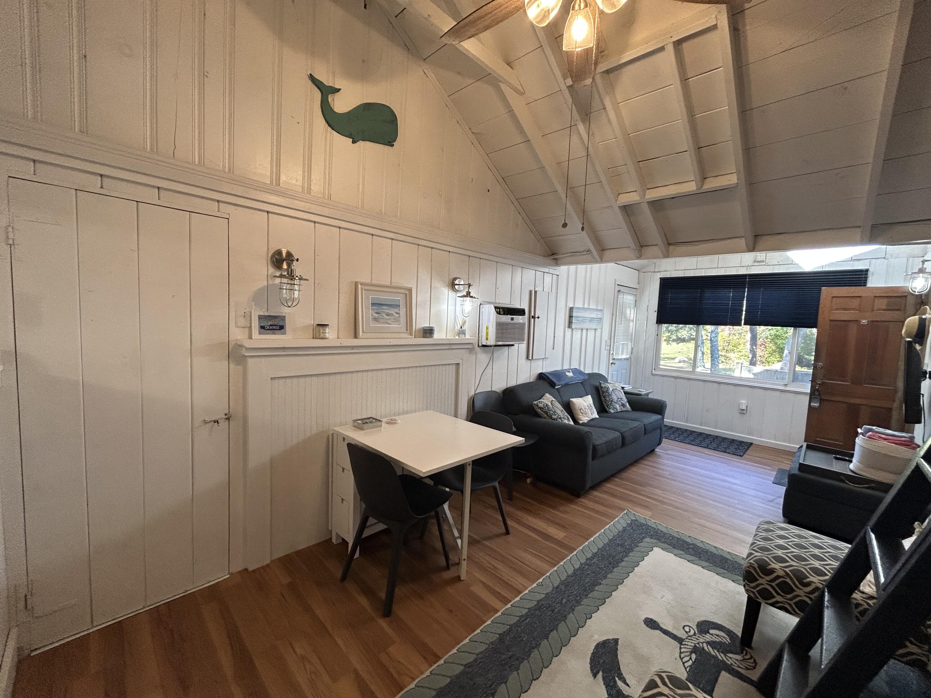 262 Old Wharf Road, Unit U67 Dennis Port, MA 02639 - Photo 29 of 54 a living room with furniture and a wooden floor