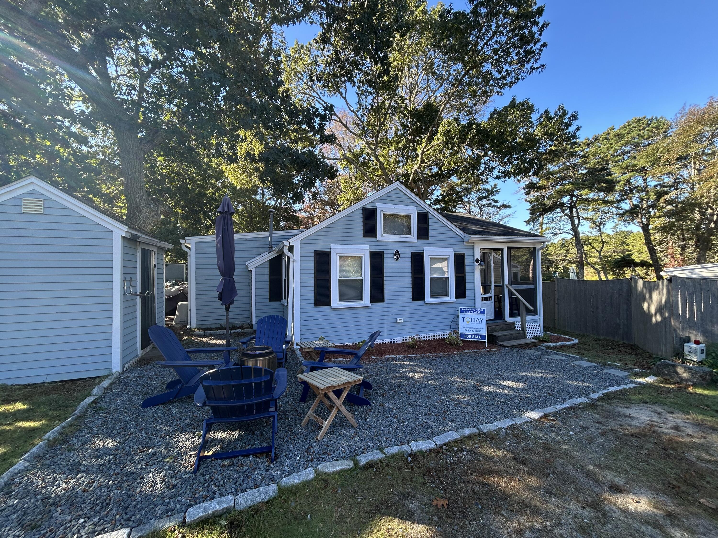 262 Old Wharf Road, Unit U67 Dennis Port, MA 02639 - Photo 42 of 54 a view of a house with a yard chairs and a patio