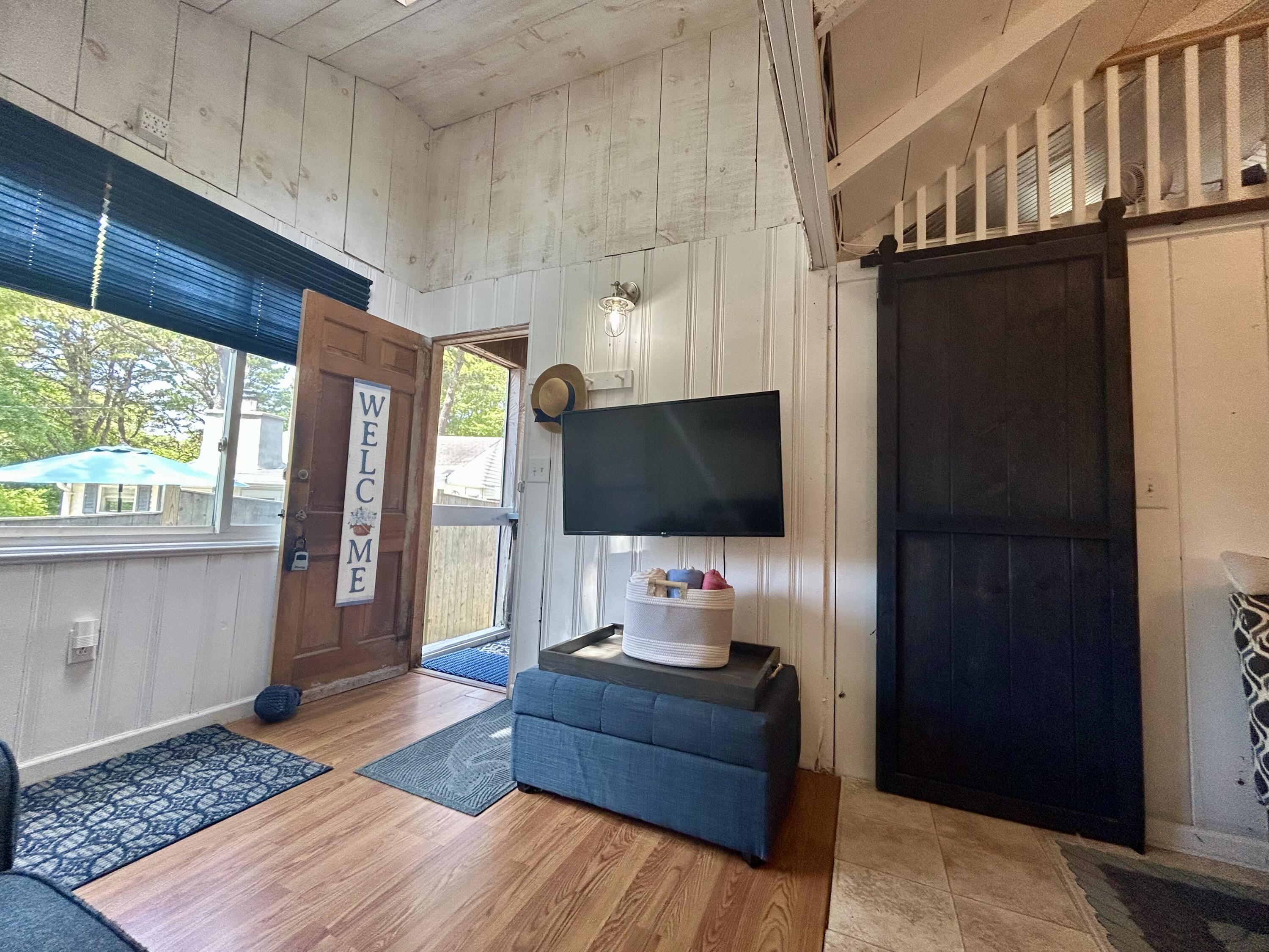 262 Old Wharf Road, Unit U67 Dennis Port, MA 02639 - Photo 9 of 54 a living room with furniture and a flat screen tv