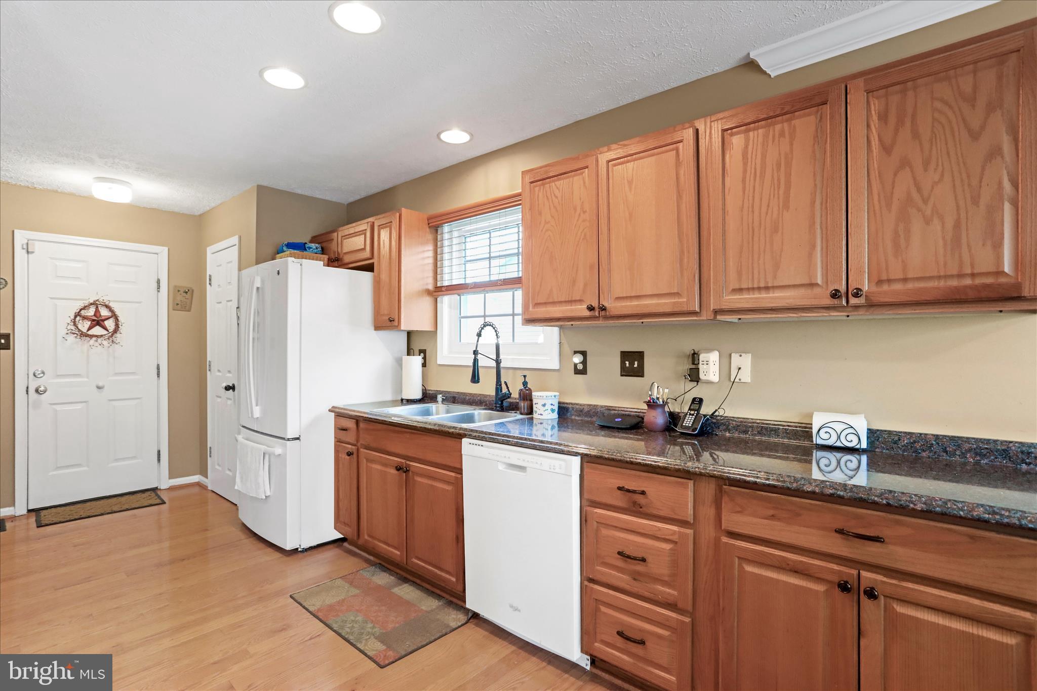 107 Briar Run Drive Ranson, WV 25438 - Photo 13 of 45 a kitchen with a sink a refrigerator and cabinets
