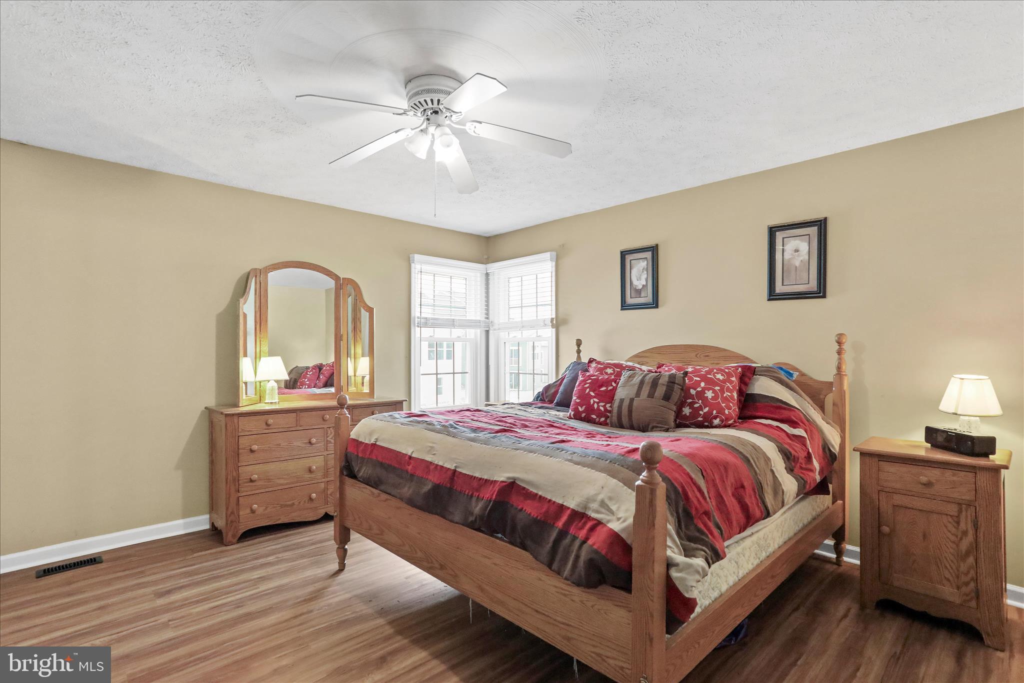 107 Briar Run Drive Ranson, WV 25438 - Photo 19 of 45 a bedroom with a large bed and a chandelier