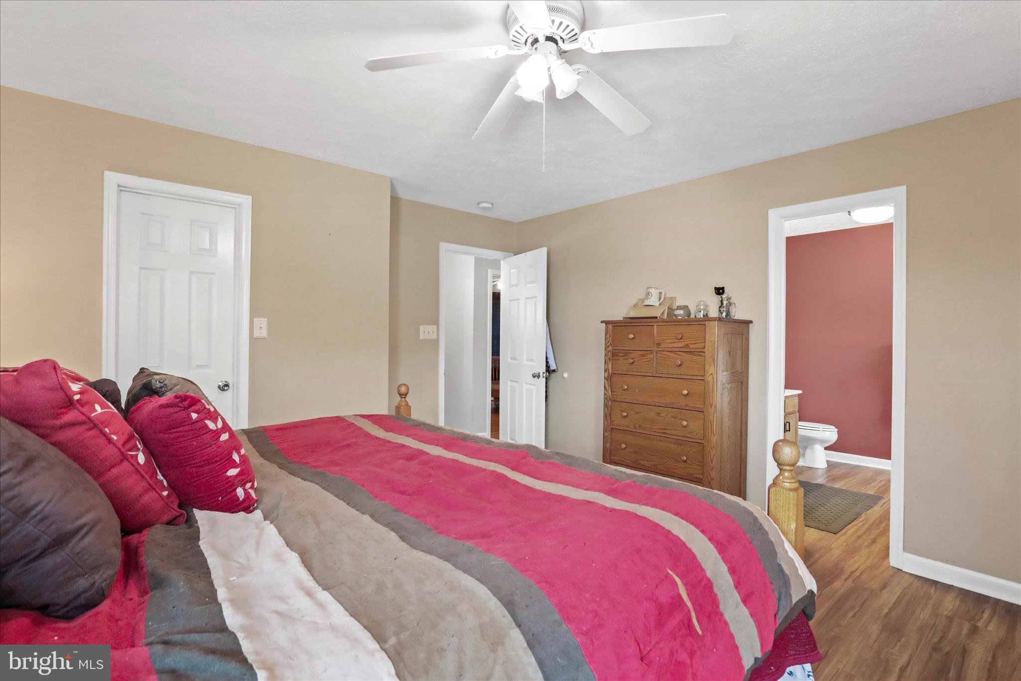 107 Briar Run Drive Ranson, WV 25438 - Photo 20 of 45 a bedroom with a bed and a chandelier