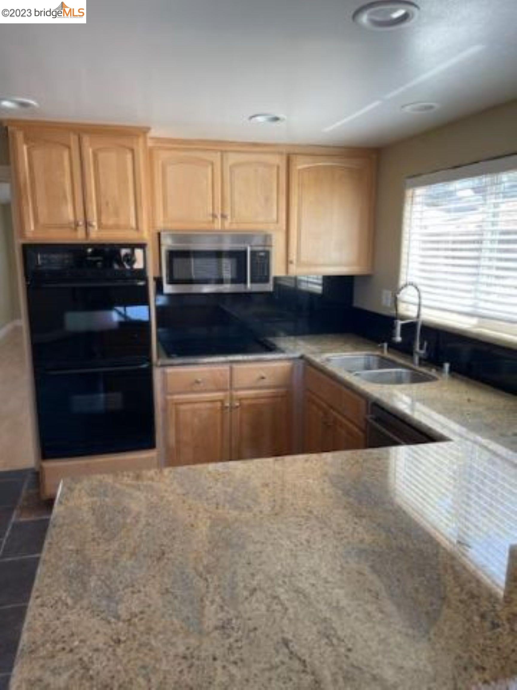 142 Encinal Place Pittsburg, CA 94565 - Photo 3 of 8 a kitchen with stainless steel appliances a sink a stove a microwave a counter top space and cabinets