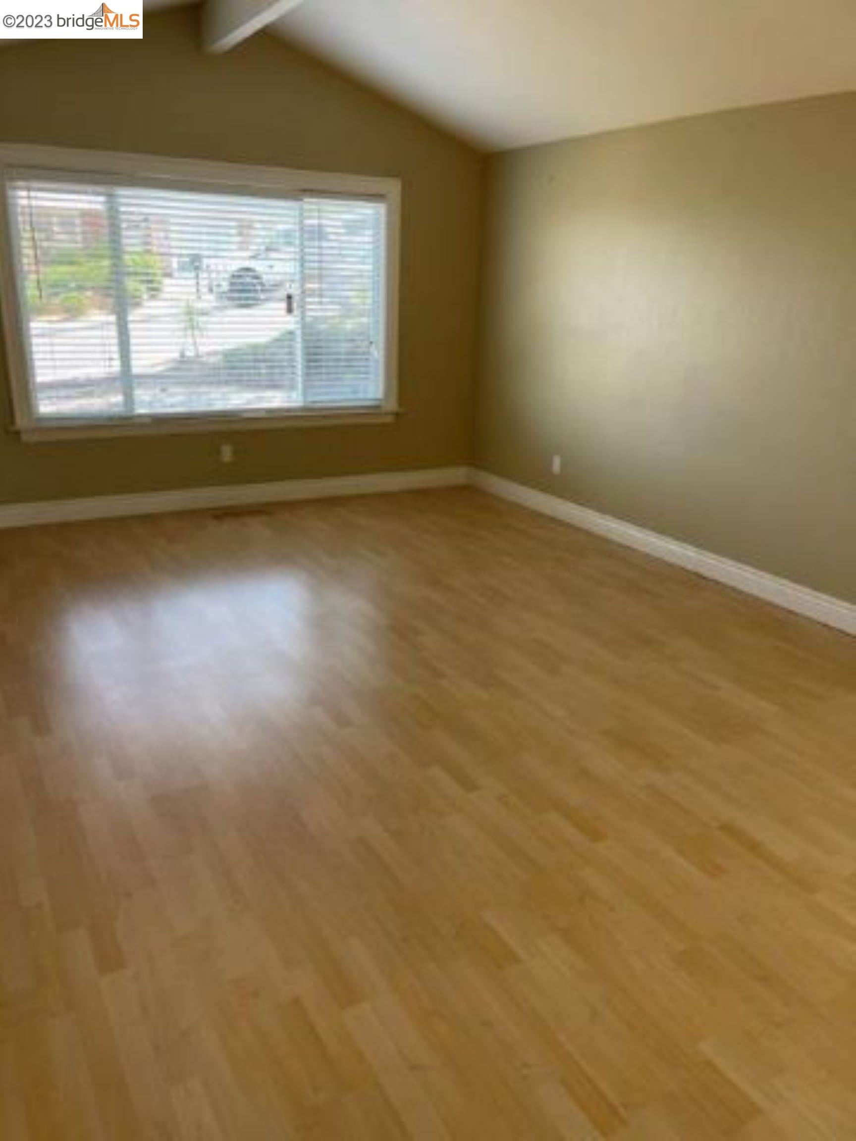 142 Encinal Place Pittsburg, CA 94565 - Photo 4 of 8 an empty room with wooden floor and windows