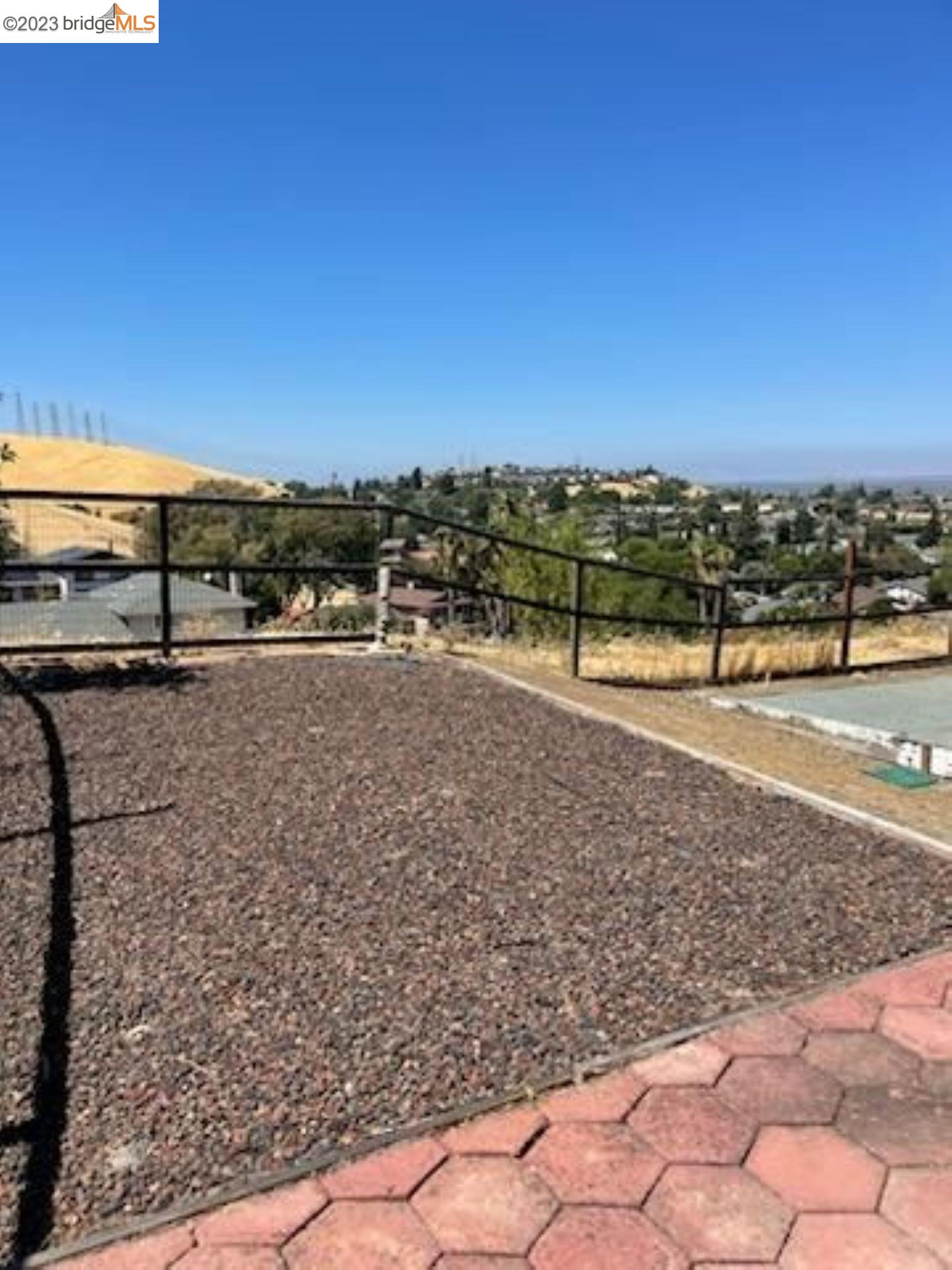 142 Encinal Place Pittsburg, CA 94565 - Photo 5 of 8 a view of a road with a building in the background