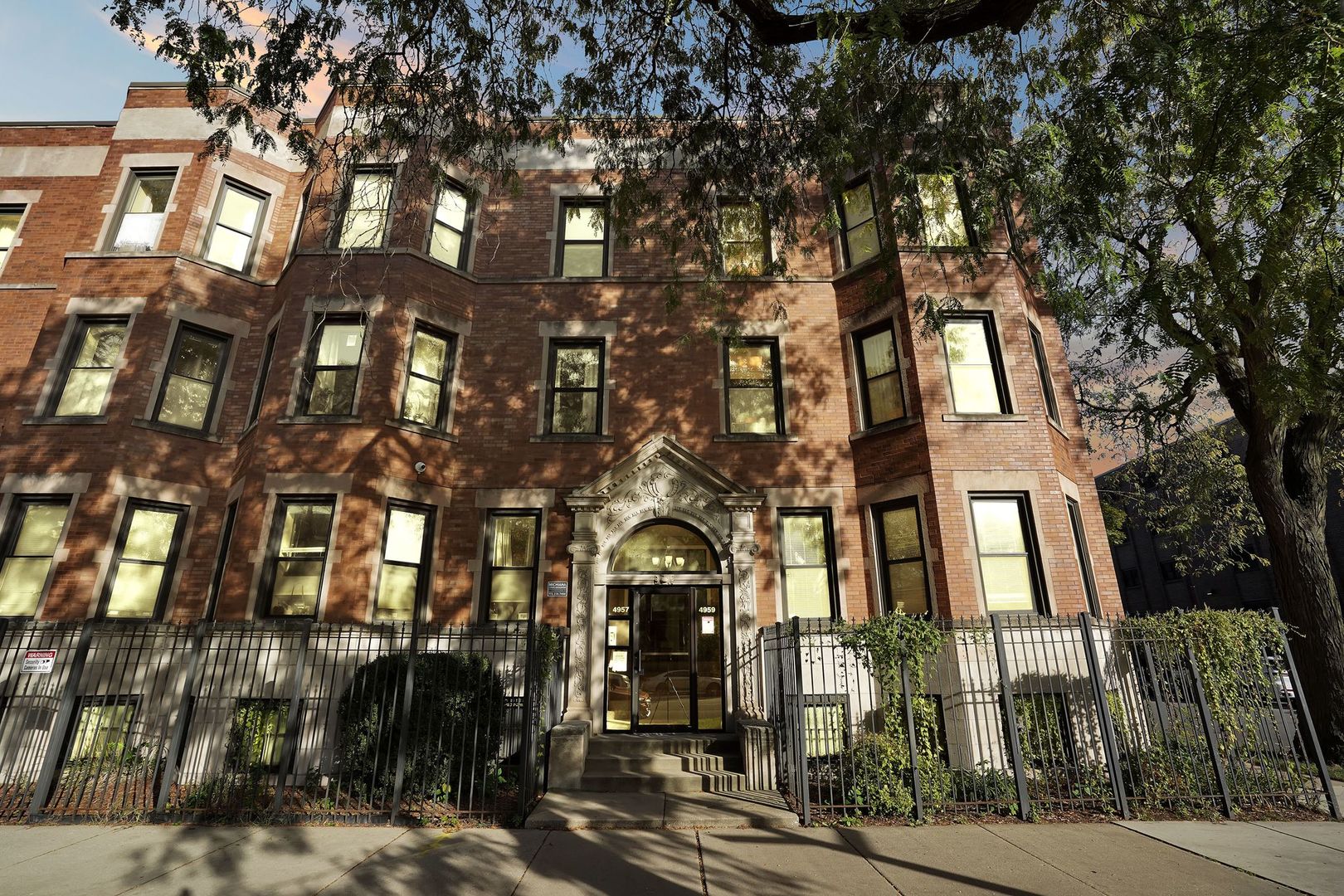 a view of a brick building next to a road