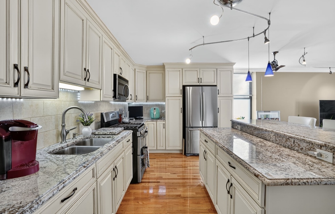 4953 South Michigan Avenue, Unit 7 Chicago, IL 60615 - Photo 3 of 13 a kitchen with stainless steel appliances granite countertop a sink stove and refrigerator