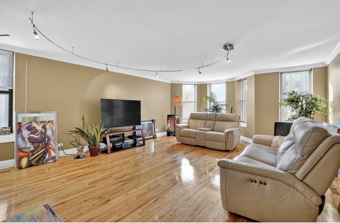 4953 South Michigan Avenue, Unit 7 Chicago, IL 60615 - Photo 4 of 13 a living room with furniture and a flat screen tv