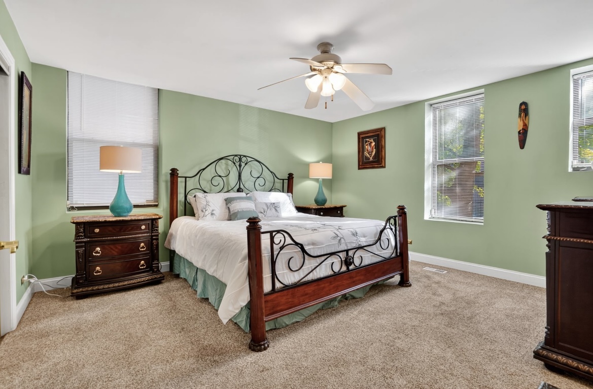 4953 South Michigan Avenue, Unit 7 Chicago, IL 60615 - Photo 5 of 13 a bedroom with a bed and a chandelier