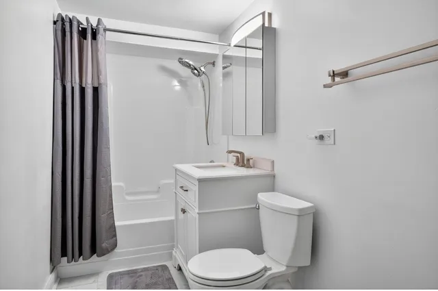 a white toilet sitting next to a bathroom sink