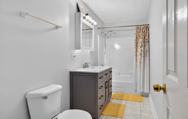 a bathroom with a sink mirror vanity and toilet