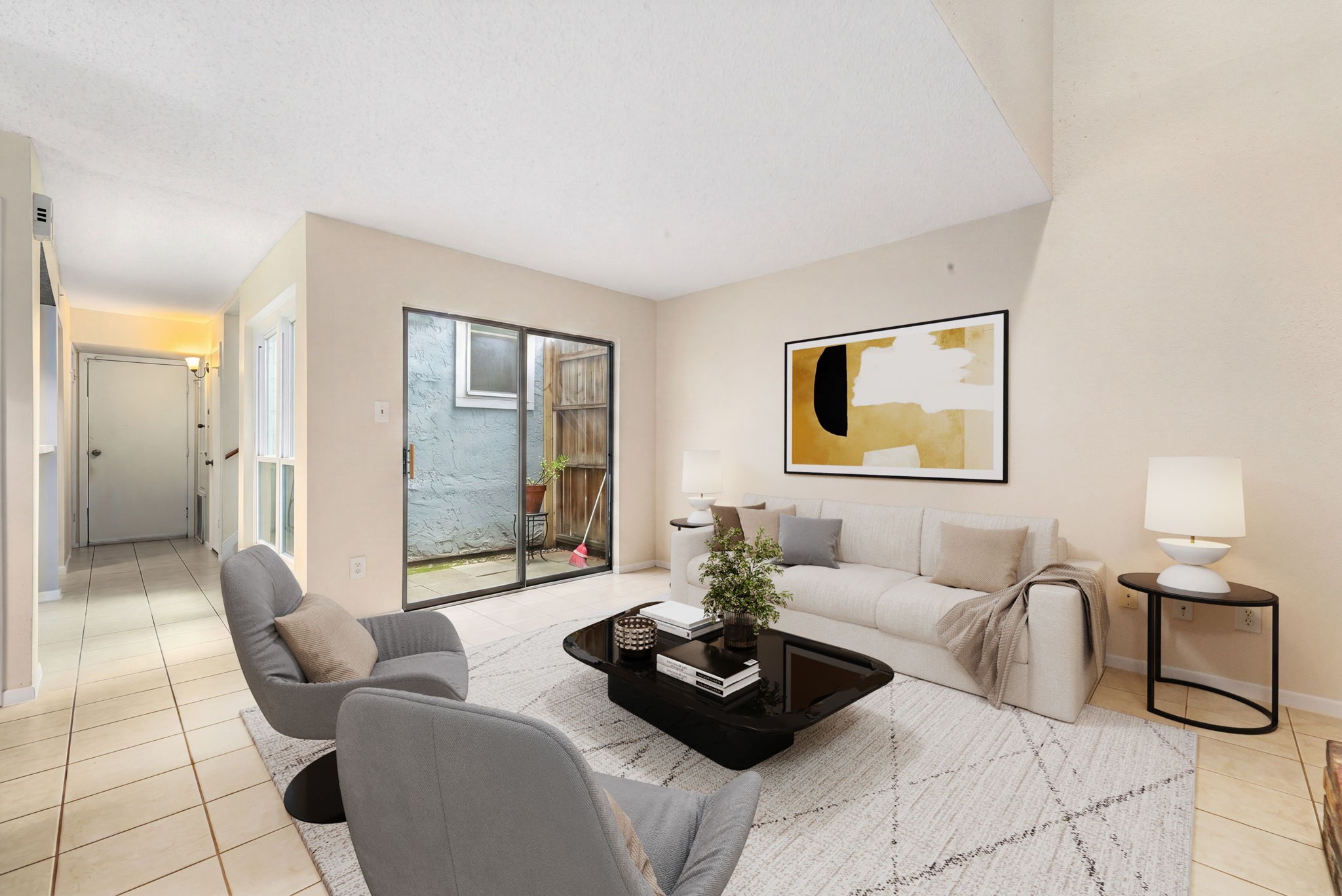 3200 South Gessner Road, Unit 228 Houston, TX 77063 - Photo 5 of 18 Another gorgeous view of the living room showcasing the vaulted ceilings, tile flooring, and a sliding glass door leading directly to the private patio, seamlessly blending indoor and outdoor living! *Virtually Staged