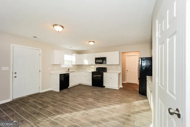 a kitchen with a refrigerator and a sink