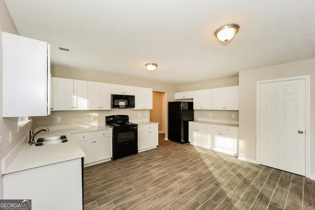 a kitchen with a refrigerator stove and sink