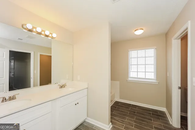 a bathroom with a sink a vanity and a mirror