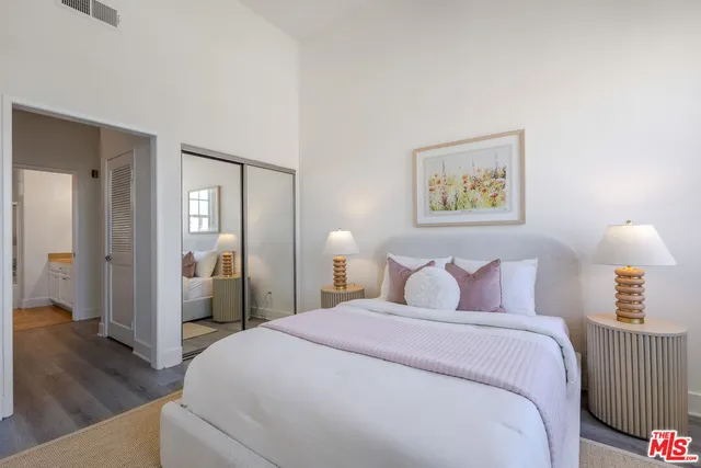 a bedroom with a bed and a lamp