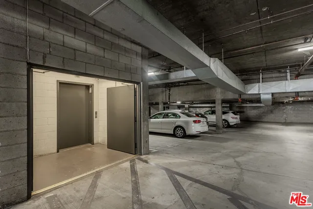 a view of parking garage with cars parked