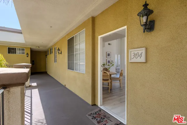 a view of a hallway with bathroom and wooden floor
