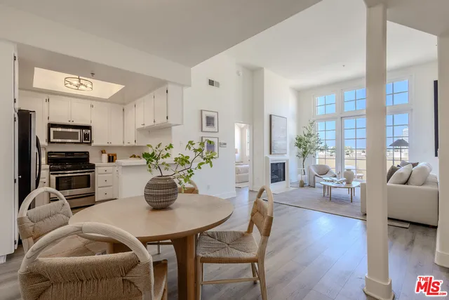 a dining room with furniture and wooden floor