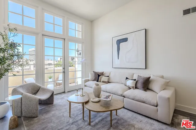 a living room with furniture and a floor to ceiling window