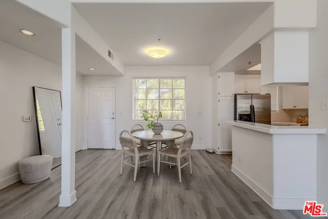 a dining room with furniture and wooden floor