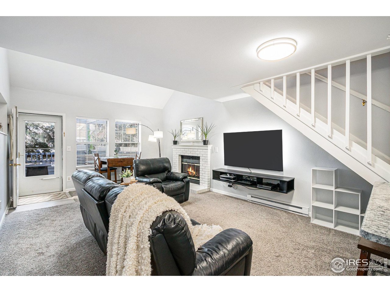 1601 West Swallow Road, Unit I Fort Collins, CO 80526 - Photo 3 of 27 Living room with wood fireplace