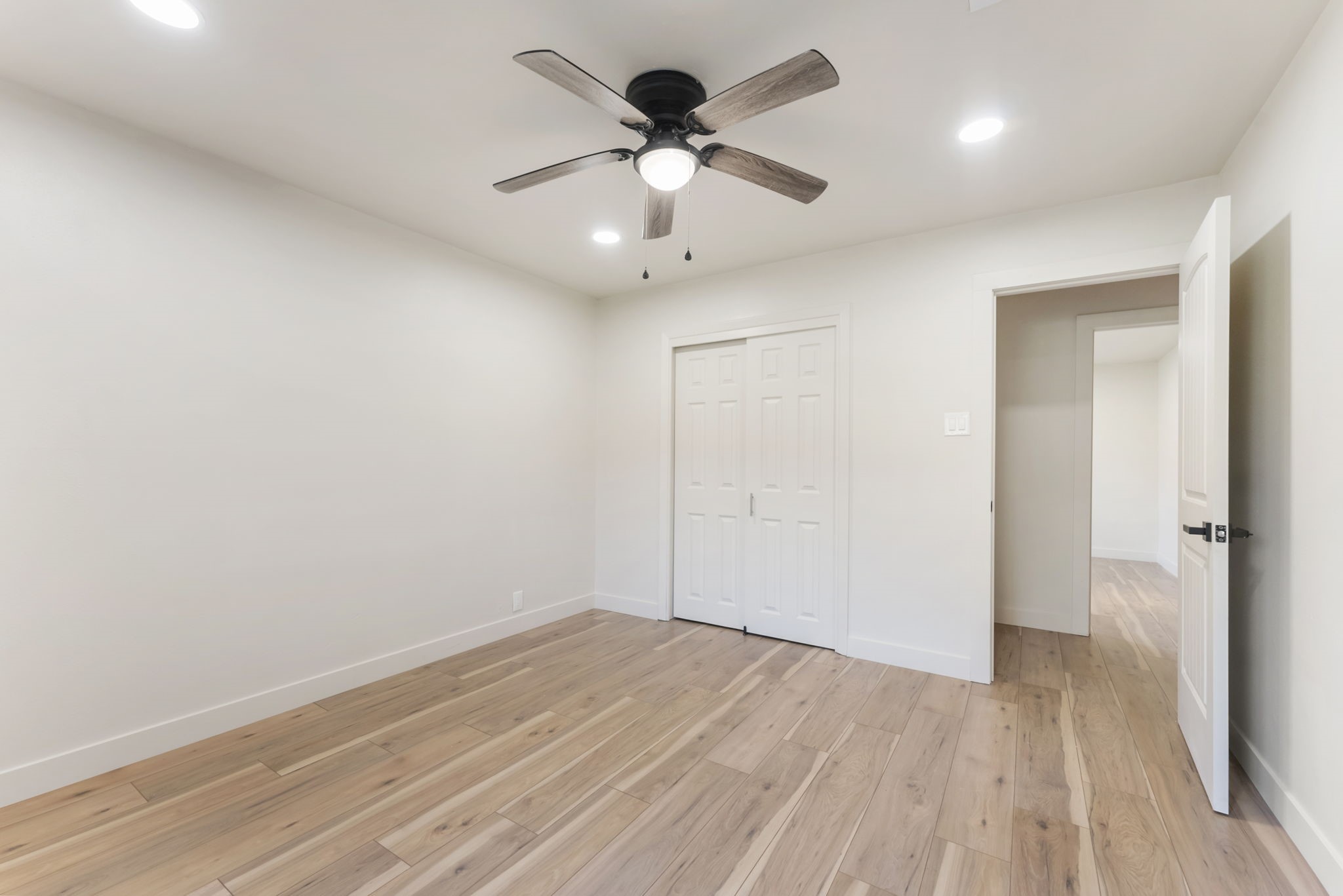 24521 Magnolia Road Hockley, TX 77447 - Photo 14 of 50 an empty room with wooden floor ceiling fan and window
