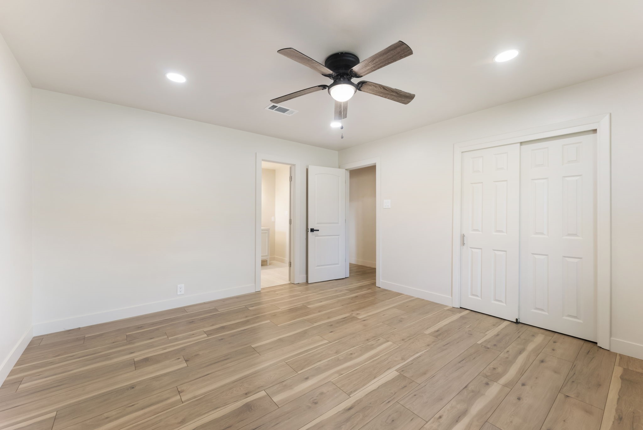 24521 Magnolia Road Hockley, TX 77447 - Photo 15 of 50 a view of an empty room with wooden floor and a ceiling fan
