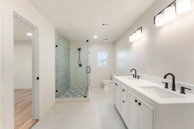 a view of a kitchen with wooden floor and a sink