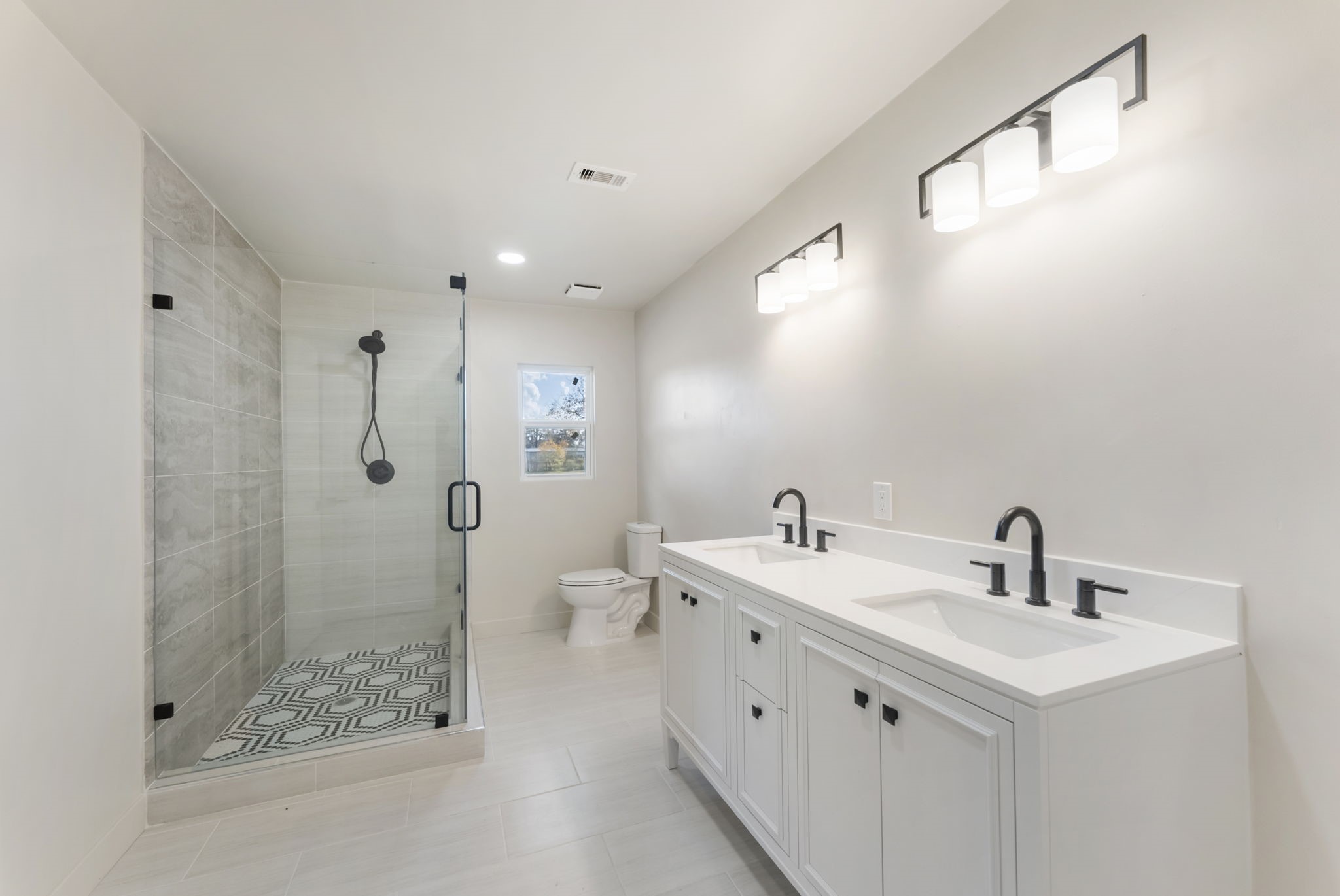 24521 Magnolia Road Hockley, TX 77447 - Photo 17 of 50 a bathroom with a double vanity sink mirror and shower