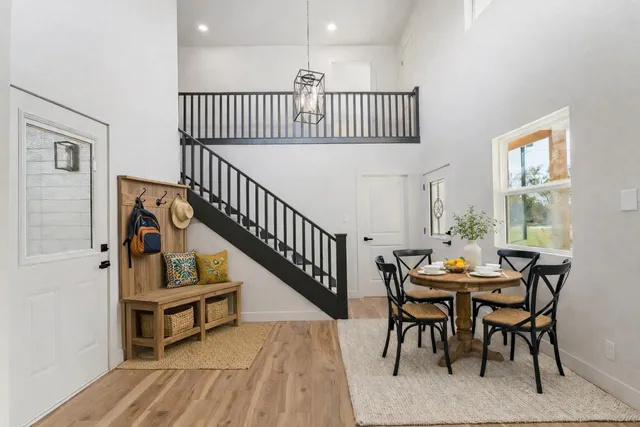 a front view of house with yard and trees in the background