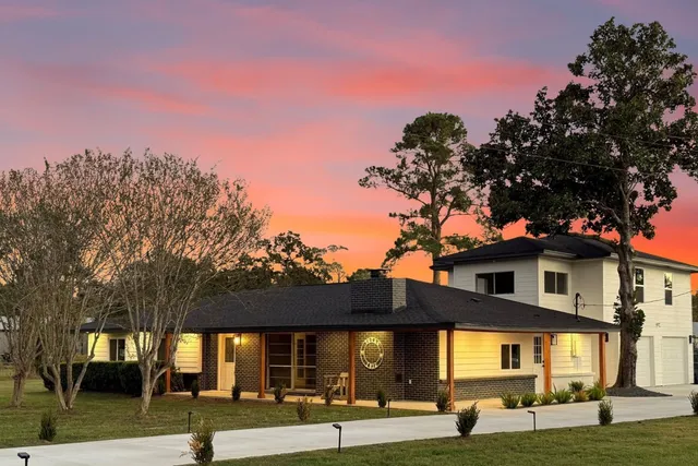 an empty room with windows and fireplace
