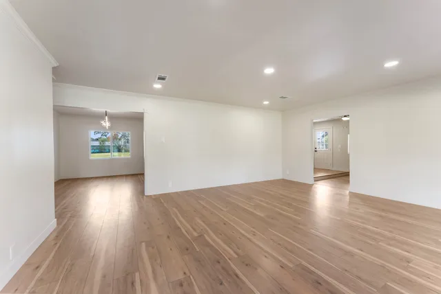 wooden floor in an empty room with a window