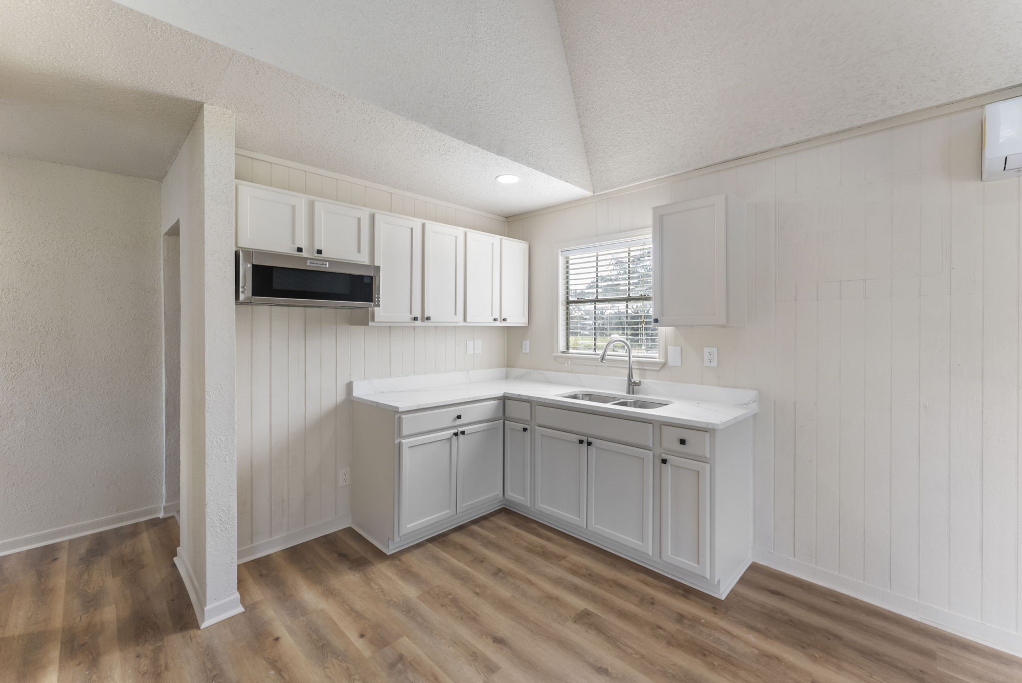 24521 Magnolia Road Hockley, TX 77447 - Photo 33 of 50 a kitchen with stainless steel appliances granite countertop a sink and dishwasher a stove top oven with wooden floor