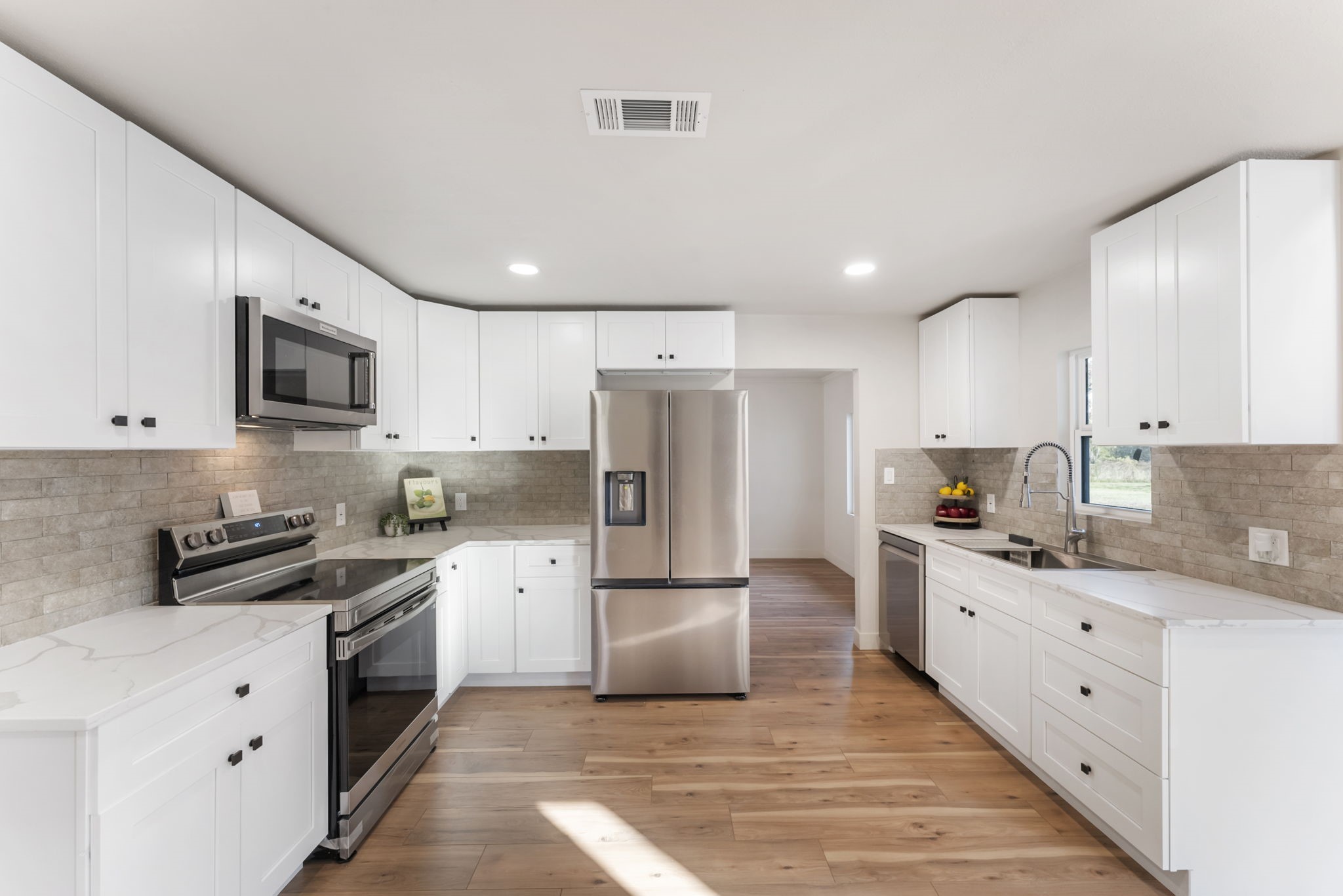 24521 Magnolia Road Hockley, TX 77447 - Photo 7 of 50 a kitchen with granite countertop a refrigerator stove top oven and sink