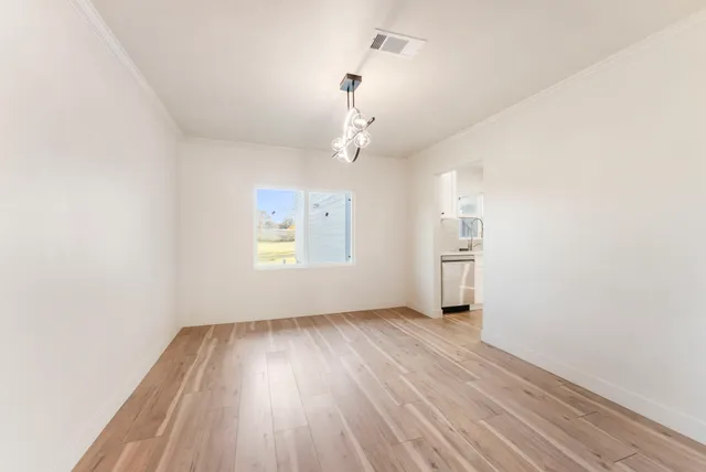 a view of staircase with wooden floor and white walls