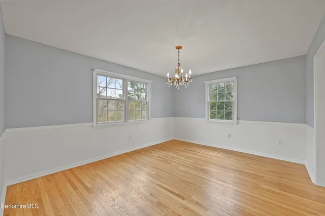a kitchen with stainless steel appliances granite countertop wooden cabinets microwave and stove top oven