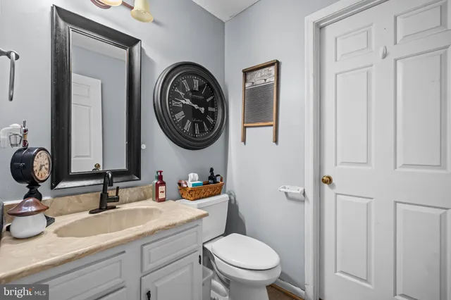 a bathroom with a toilet a sink and a mirror