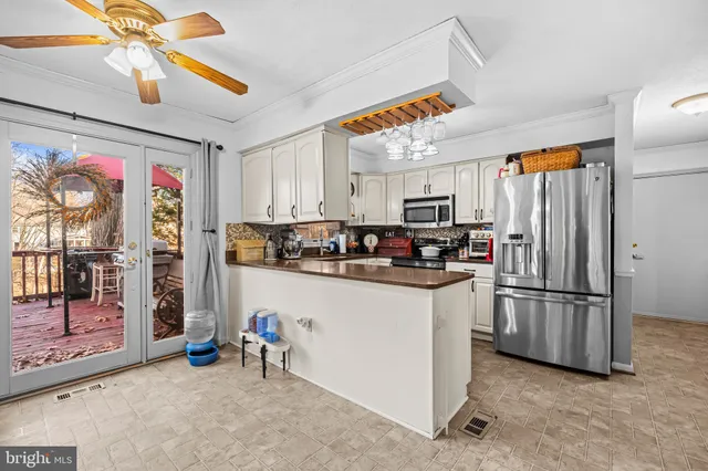 a kitchen with stainless steel appliances granite countertop a refrigerator oven a sink and dishwasher