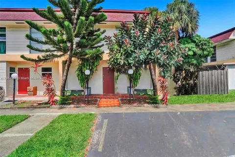 a tall building with trees in front of it