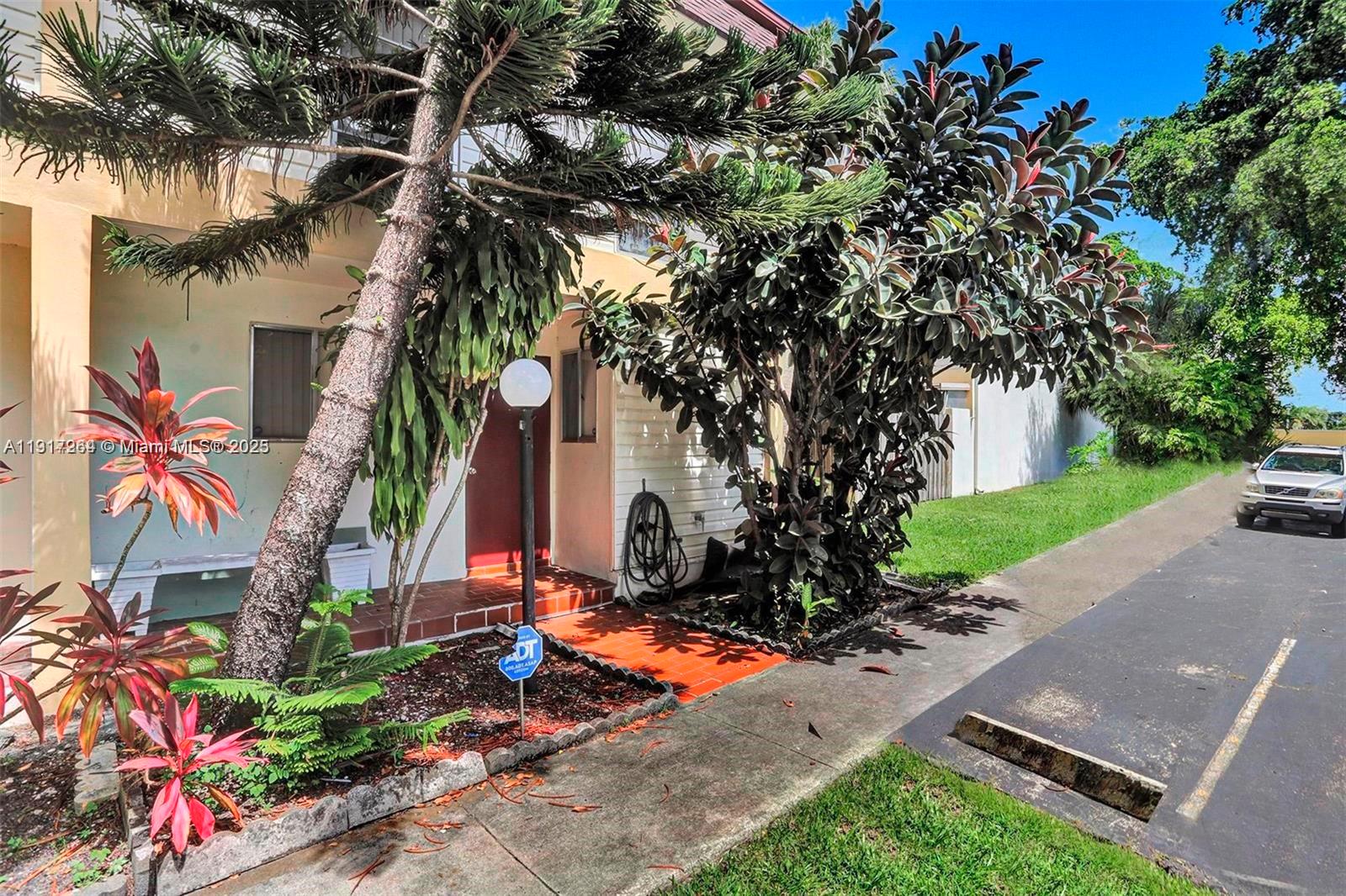 2701 North 34th Avenue, Unit 1D Hollywood, FL 33021 - Photo 3 of 9 front view of a house with a small yard