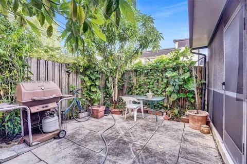 a view of a backyard with sitting area
