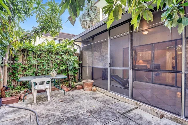 a backyard of a house with table and chairs