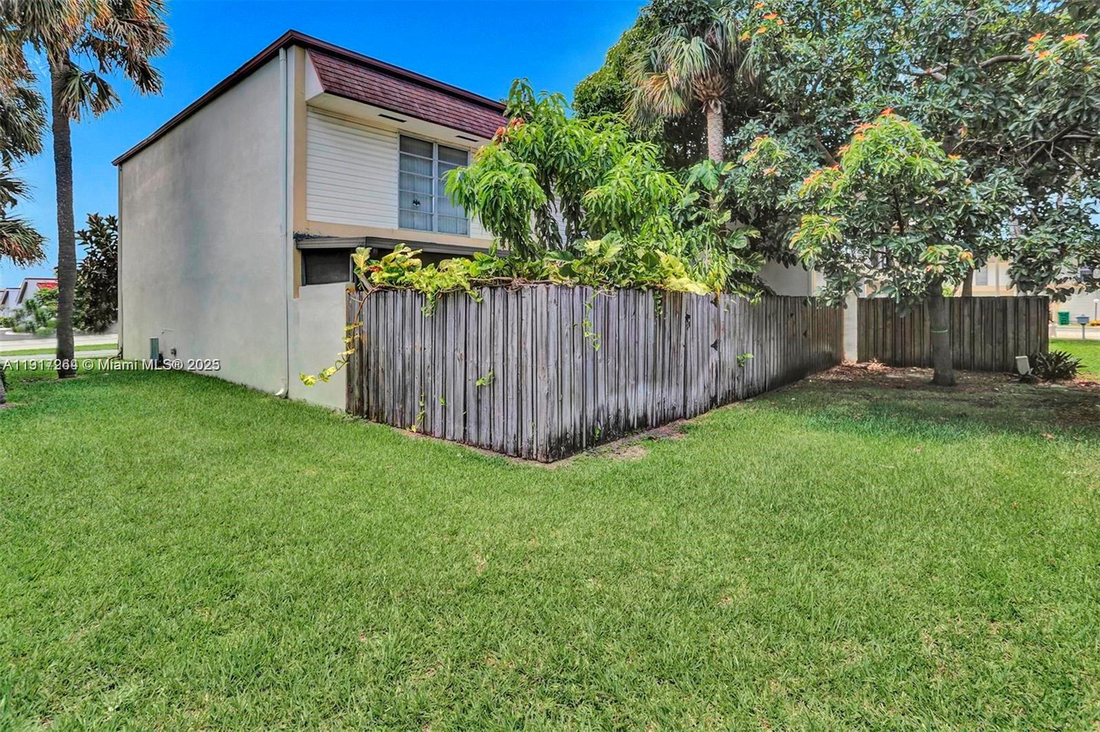2701 North 34th Avenue, Unit 1D Hollywood, FL 33021 - Photo 9 of 9 a view of a backyard with a small cabin and wooden fence