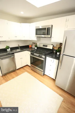 a kitchen with a sink a microwave a stove and refrigerator